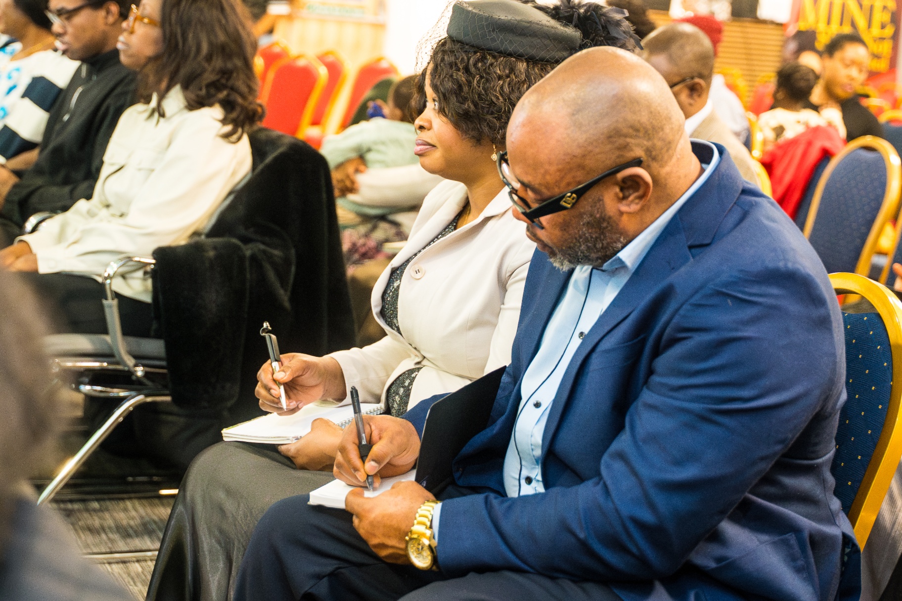 Couple taking notes during a service