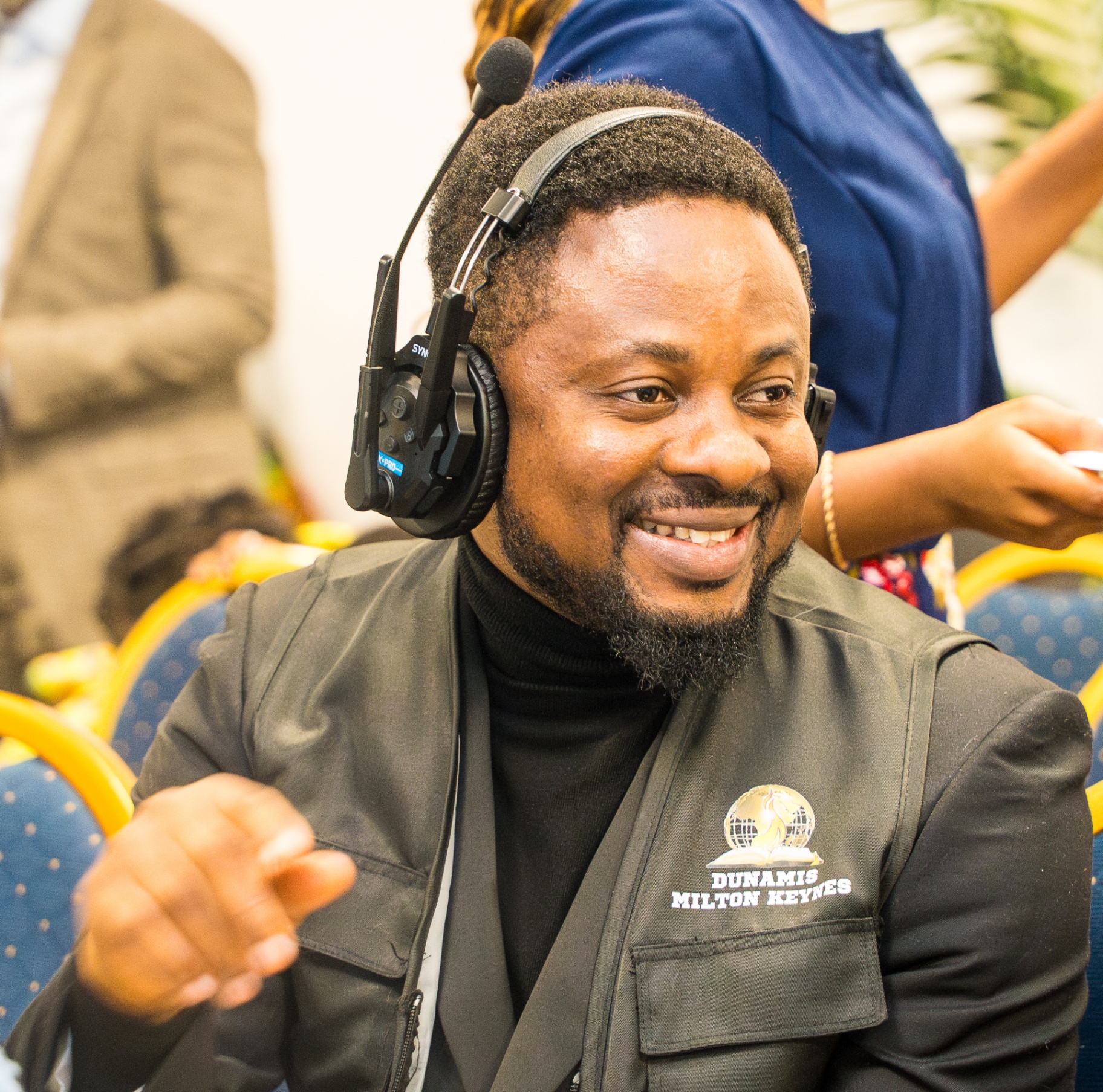 Media team member smiling during service