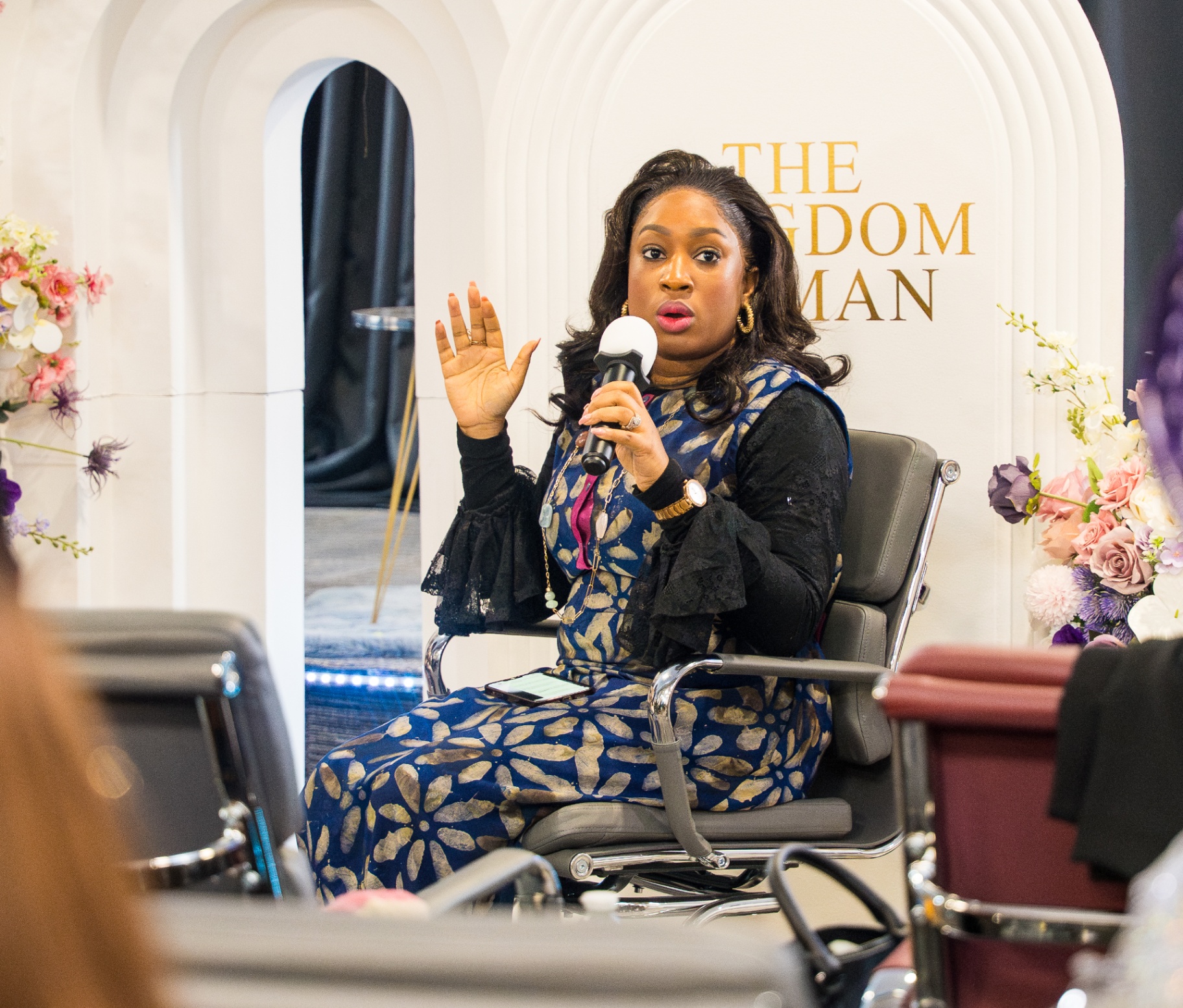 Speaker seated and ministering at The Kingdom Woman event