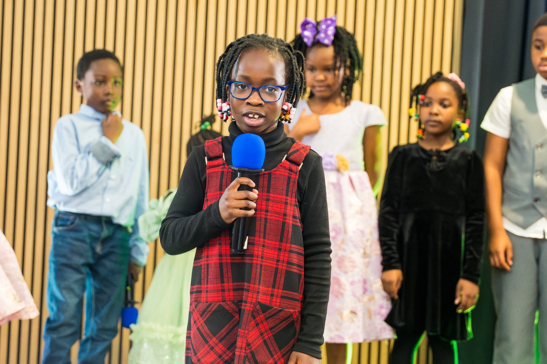 Kids and youth standing together during a church presentation