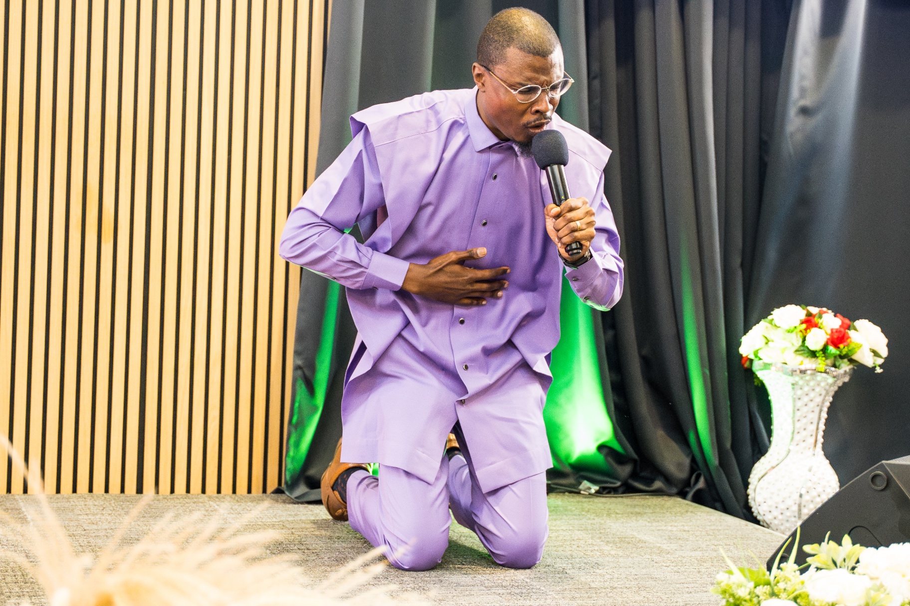 Minister preaching on his knees