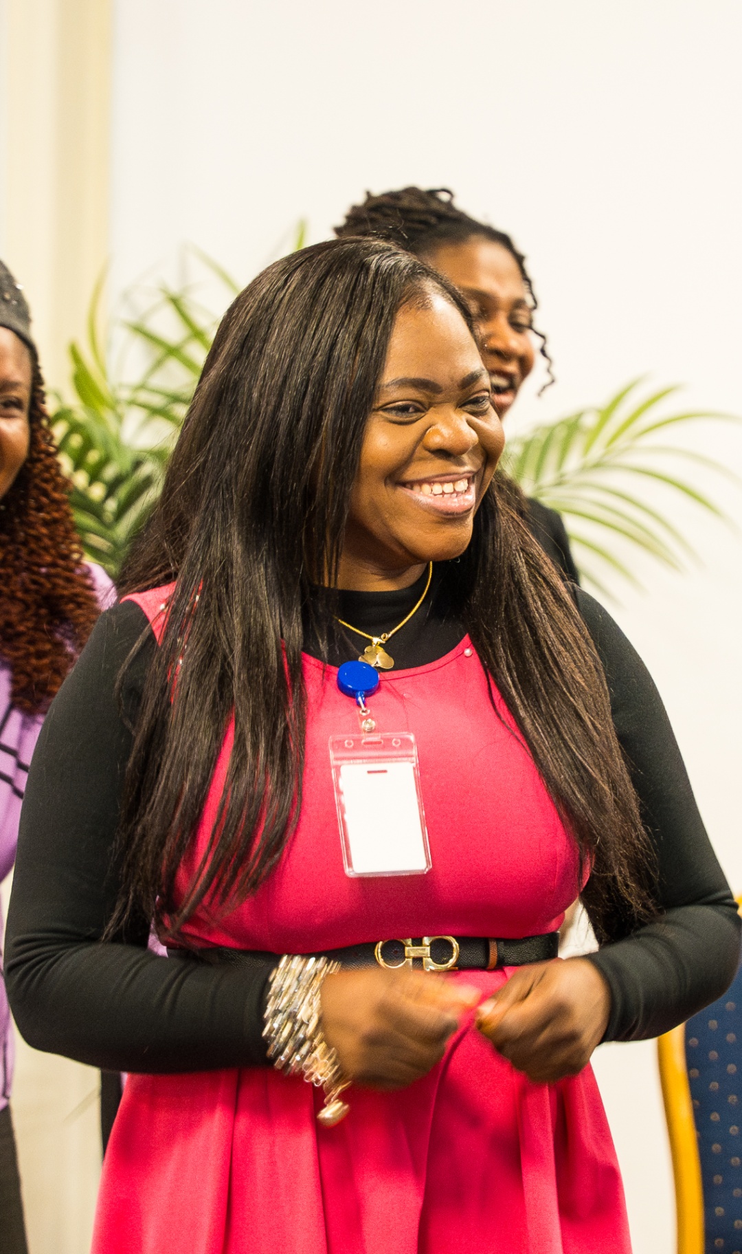 Woman in a red dress smiling during fellowship time