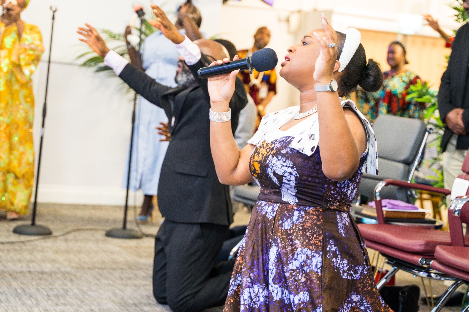 Woman leading worship with microphone
