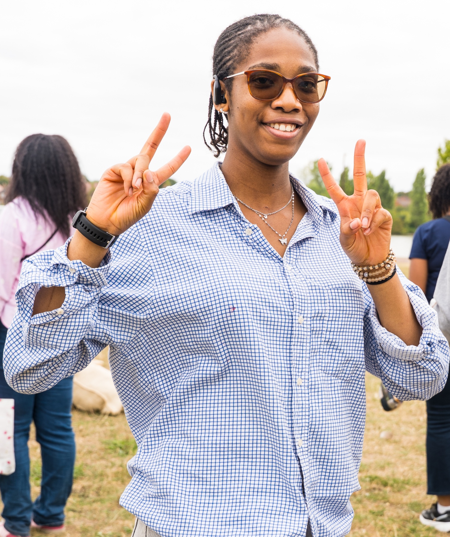 Young woman smiling with peace signs during church outing