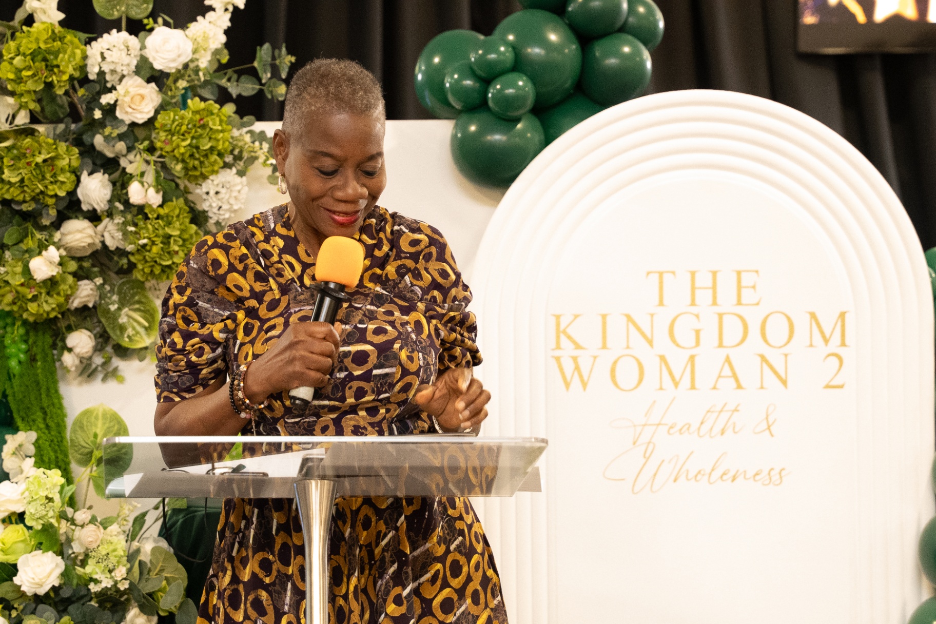 Woman reading at The Kingdom Woman 2 conference lectern