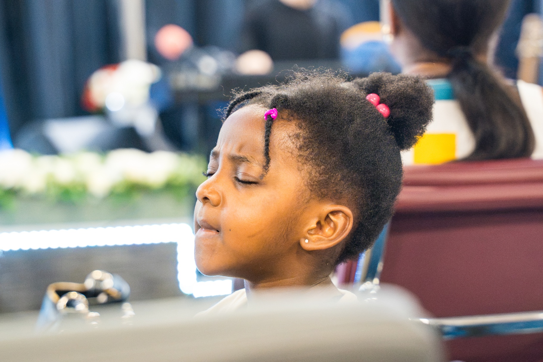 Little girl with eyes closed in a moment of prayer