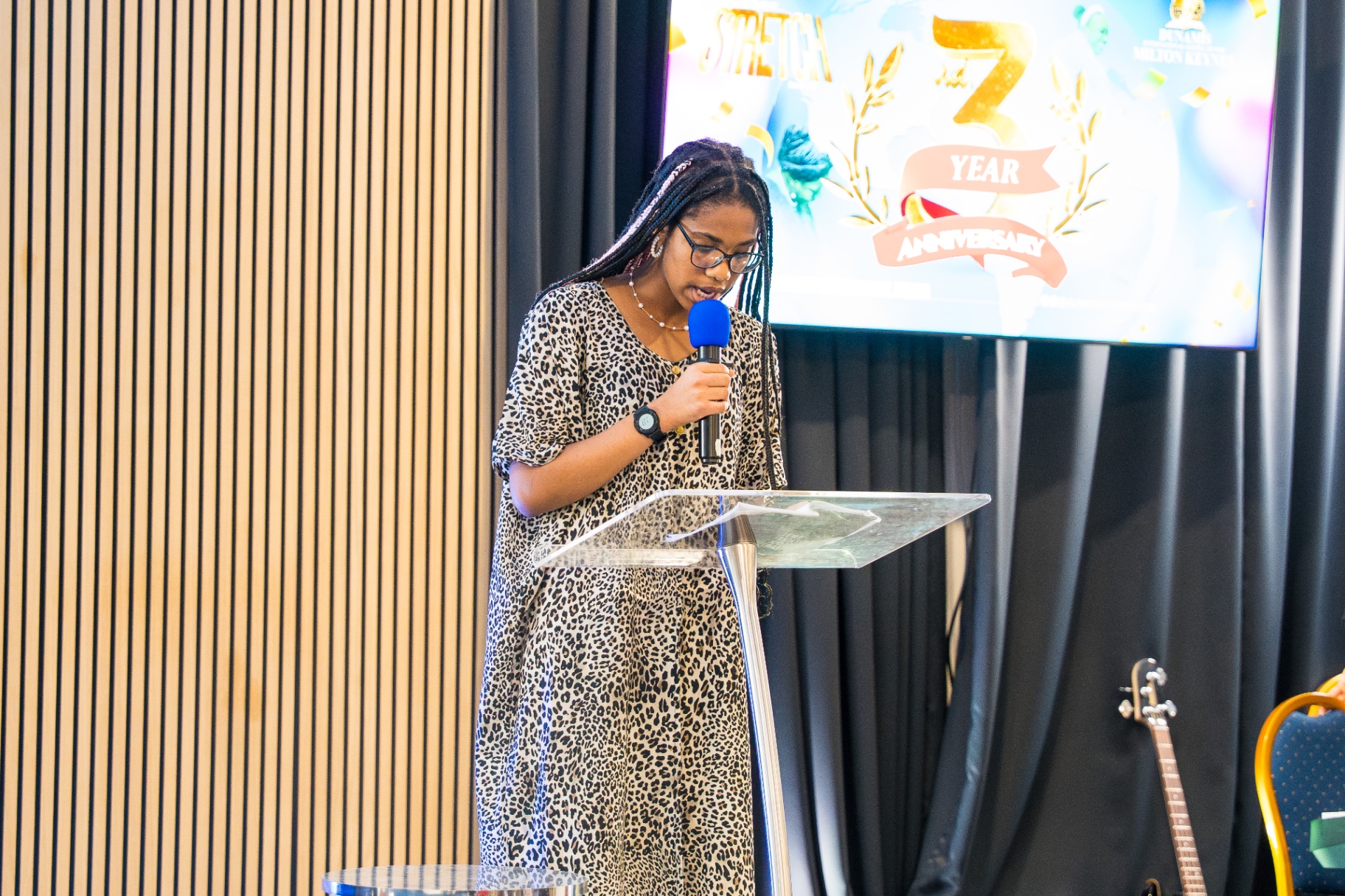 Young member speaking at the lectern during anniversary service