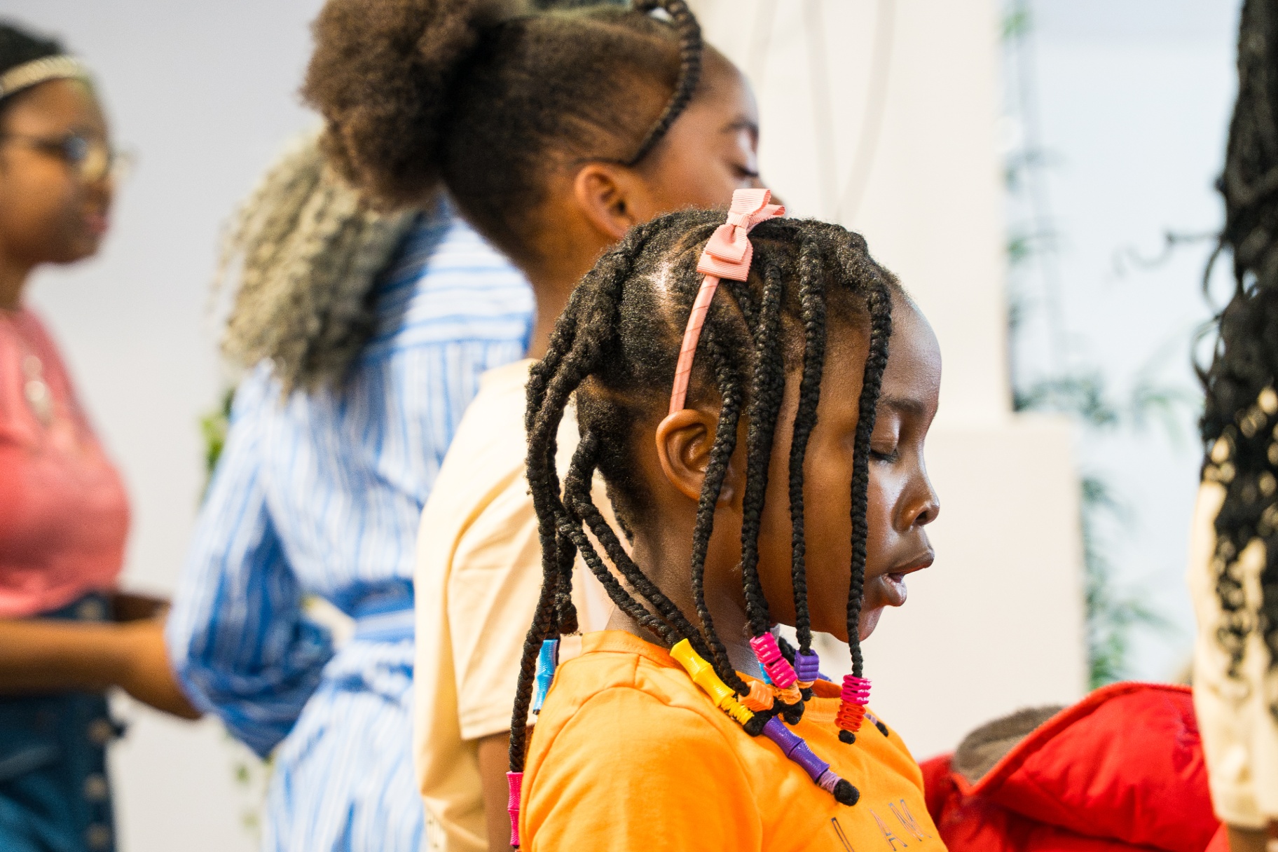 Young girl in profile praying during service