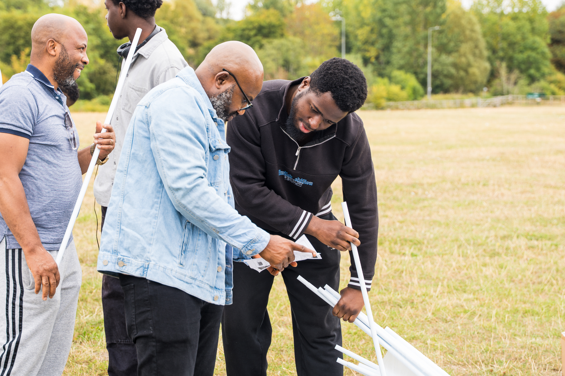 Brothers setting up together at an outdoor church gathering