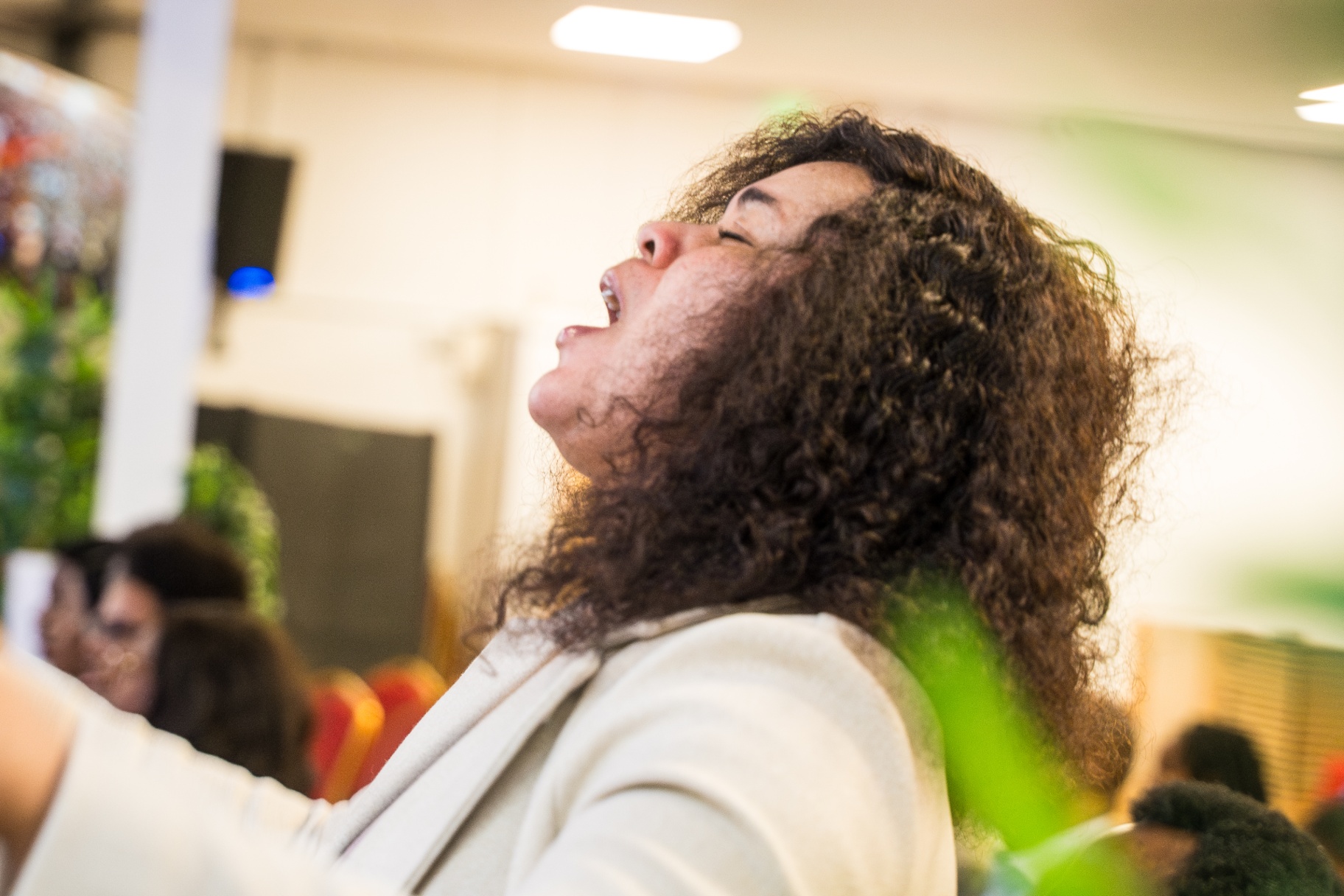 Woman worshipping passionately with head lifted in God's presence