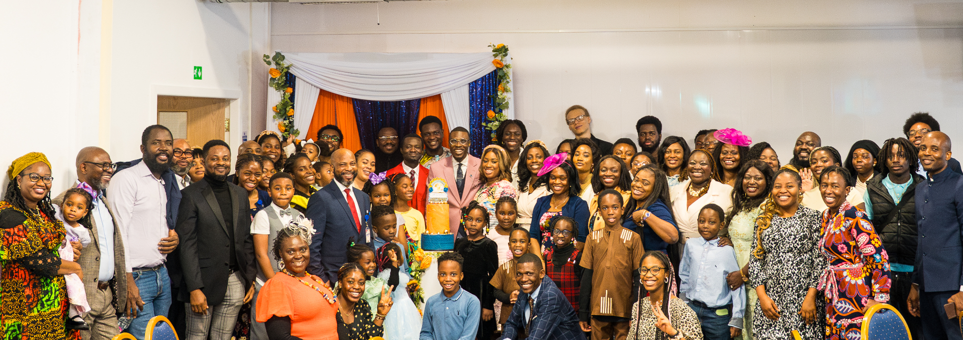 Whole church family group photo with anniversary cake