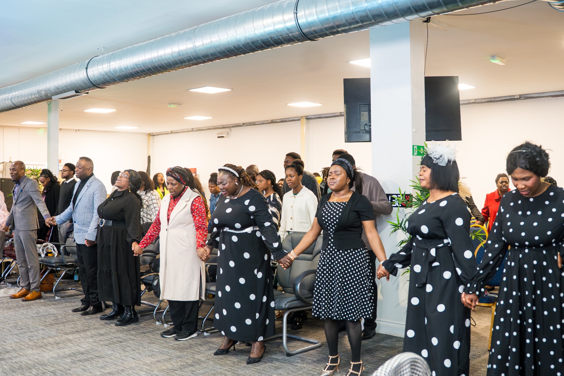 Congregation holding hands in prayer