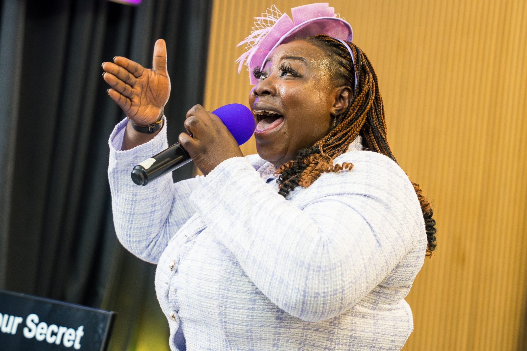 Worship leader singing passionately with a purple microphone