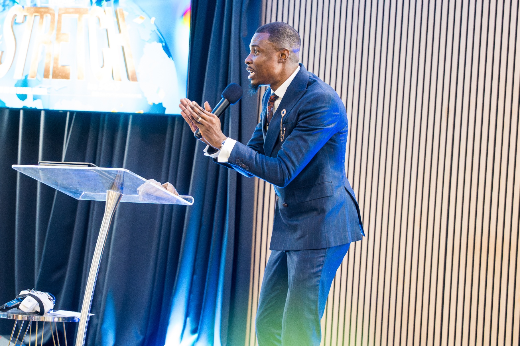 Minister preaching beside the lectern during Stretch service