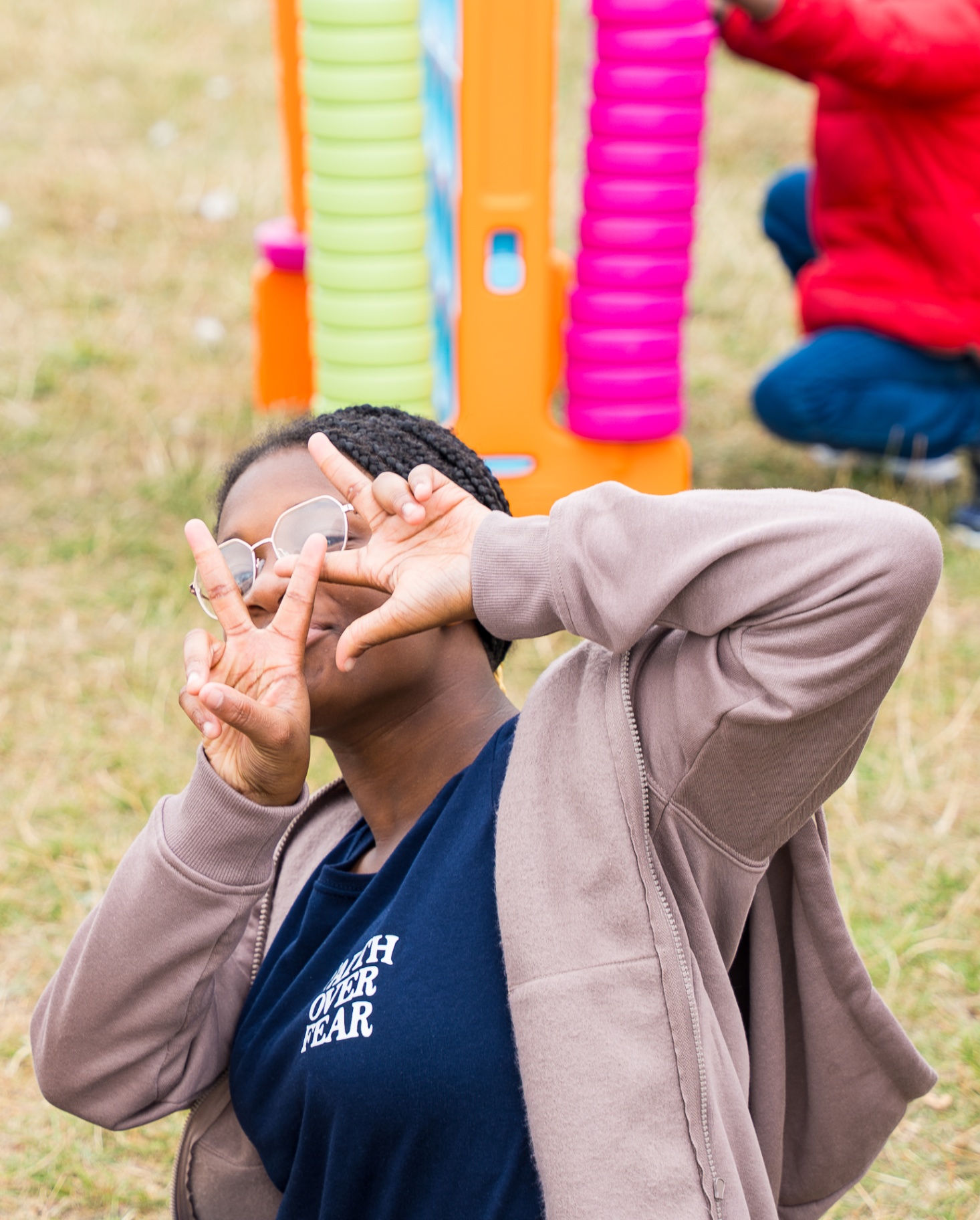 Church member wearing Faith Over Fear hoodie at outdoor family day