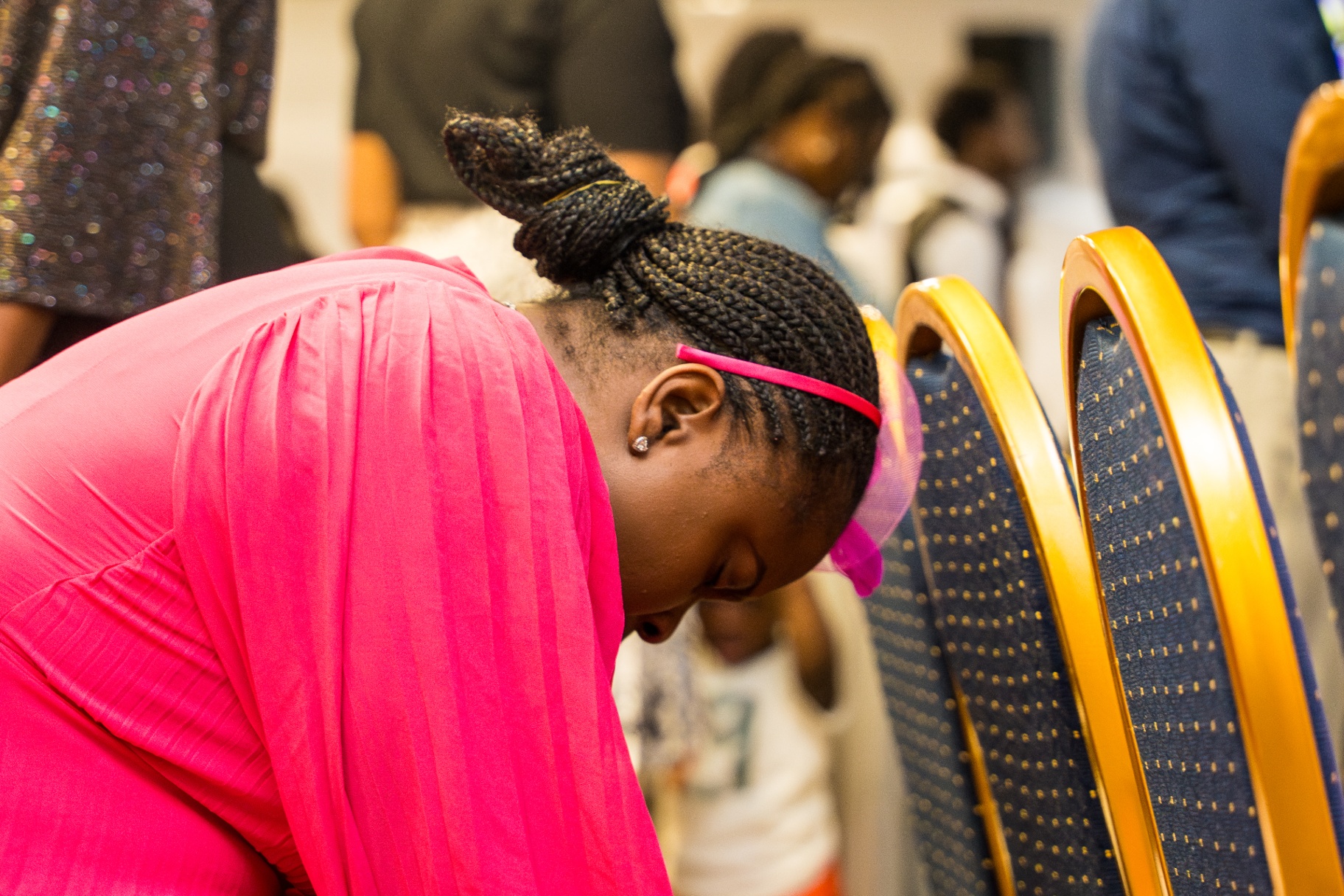 Young Woman bowed in prayer during service