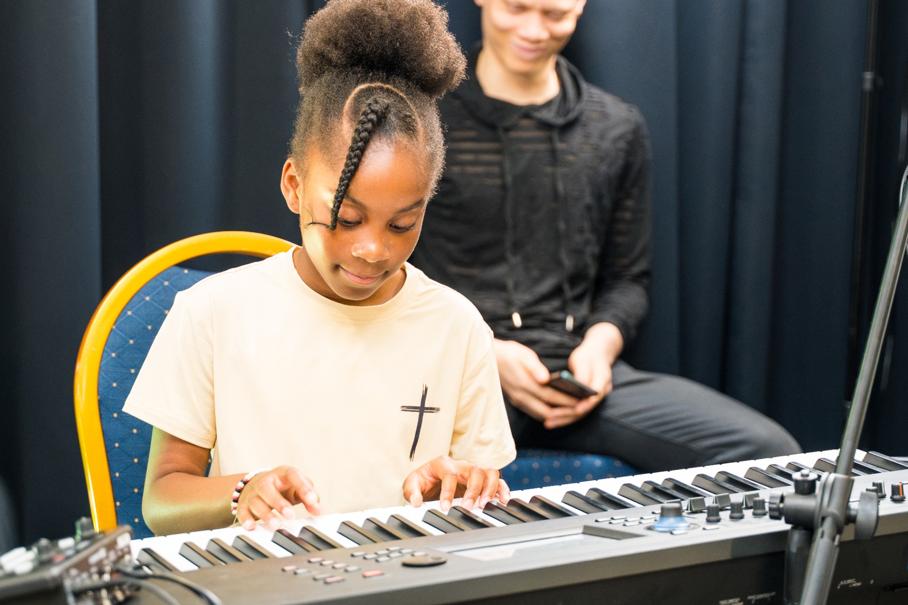 Young girl playing keyboard during Kids and Youth worship