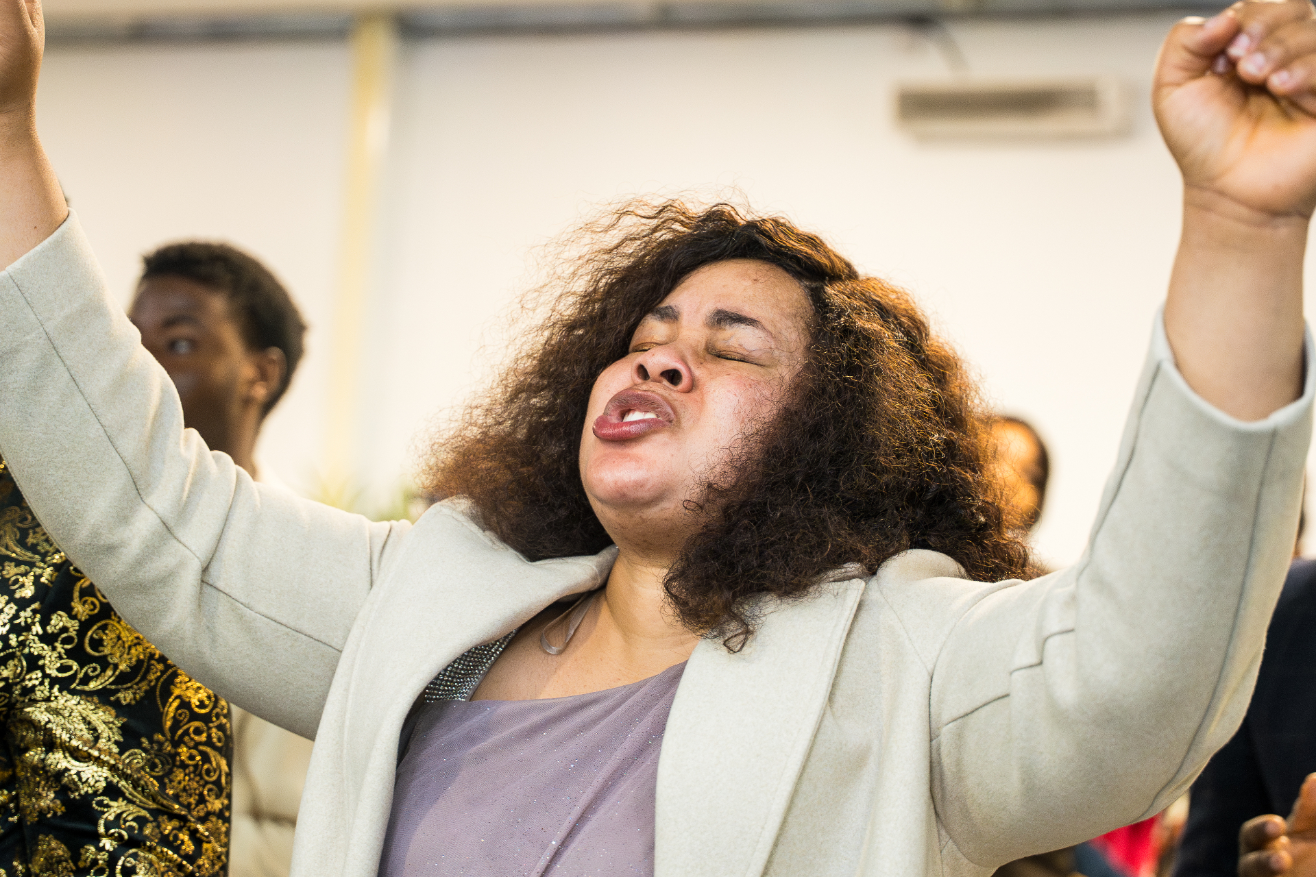 Woman with arms raised passionately in worship