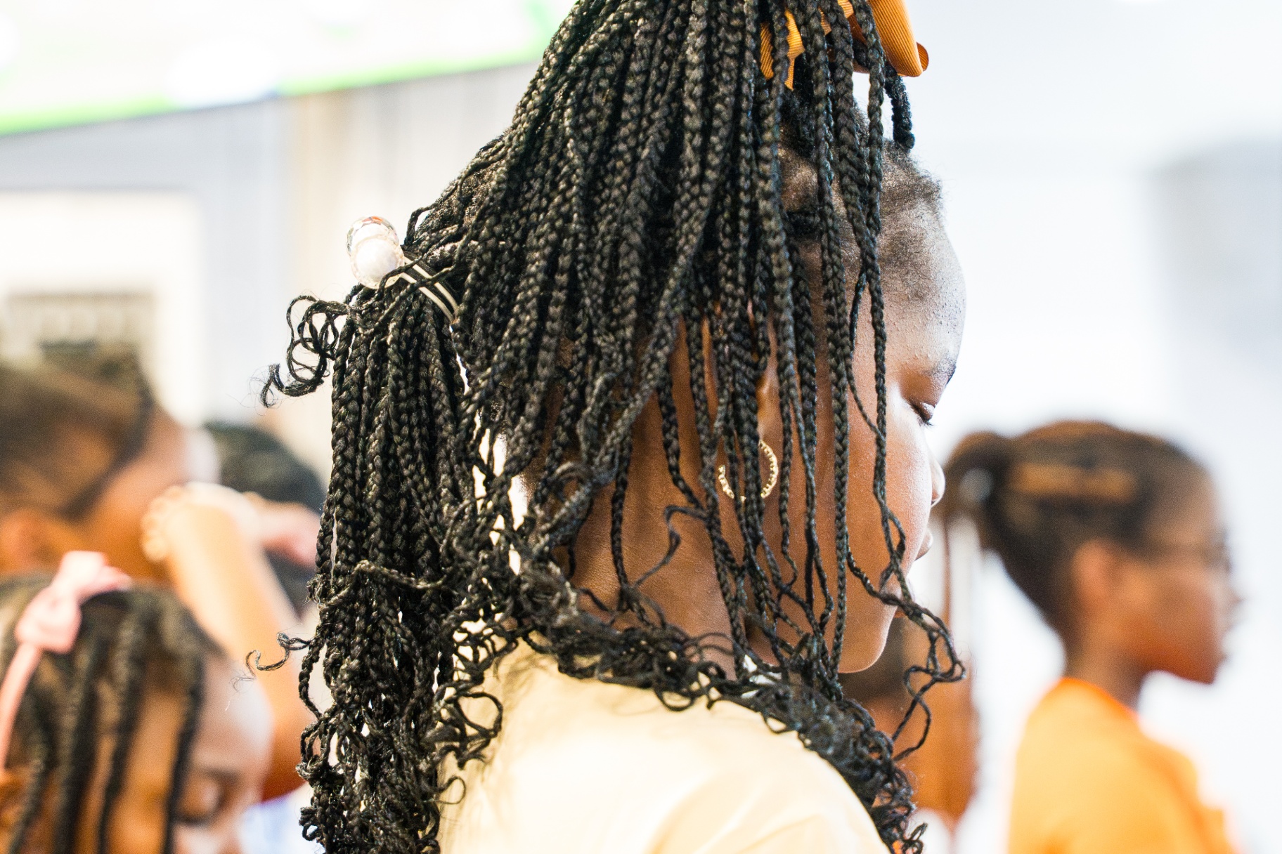 Braided young girl standing reverently during worship