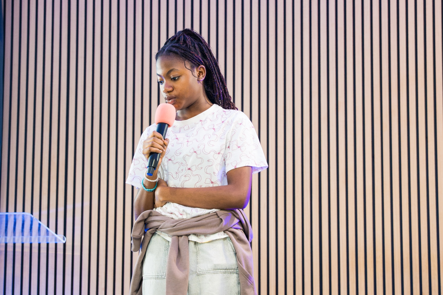 Young girl speaking into a microphone at the lectern